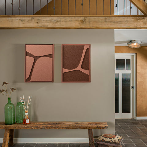 FeltArt 'Serene' in the color terra bloom, 60x80 on a wall above a wooden bench with decorative items.