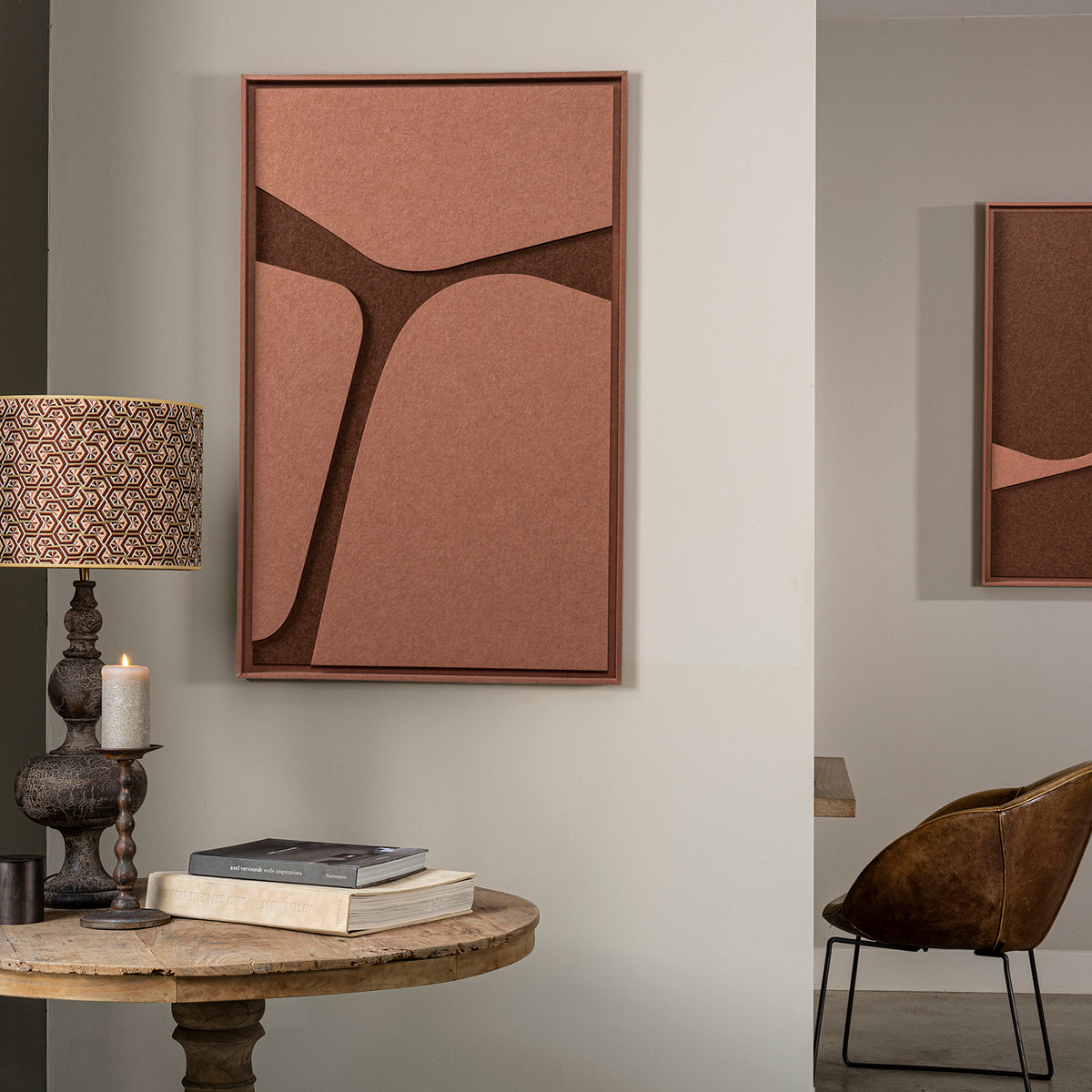 Room interior with FeltArt 'Serene' in the color terra bloom, 70x110, table, and chair.