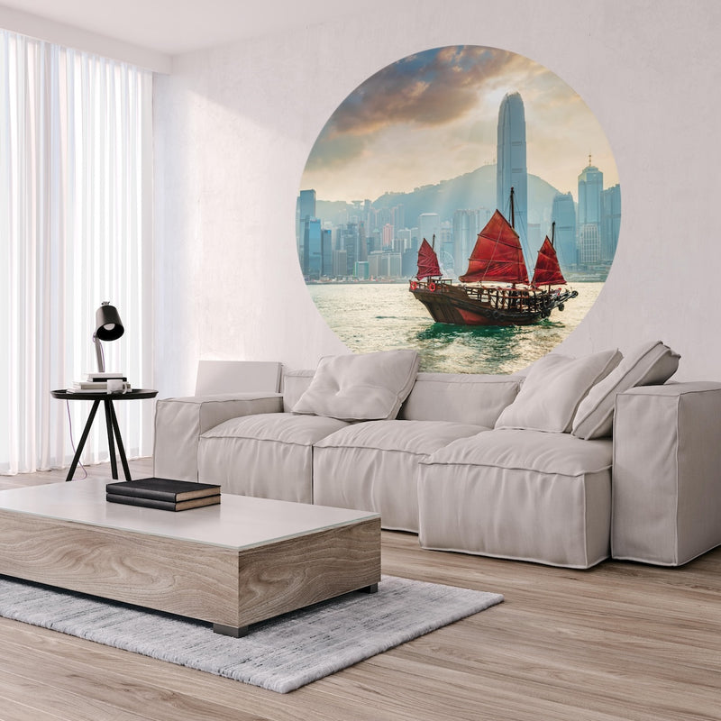 Living room with a grey couch and a Wallpaper circle of a Skyline Junk Boat.